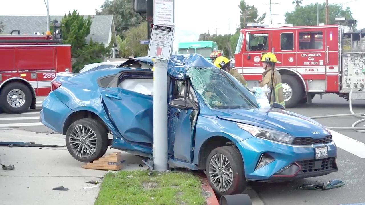 2-Vehicle Crash Traps Driver Inside Sedan Wrapped Around Pole ...